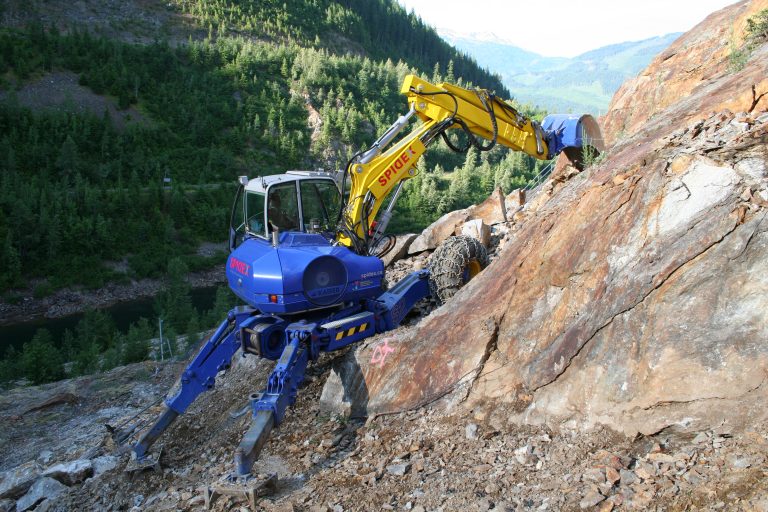 The Spidex walking excavator anchored on a steep rocky alpine slope